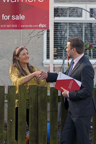 Agent shaking hands with seller